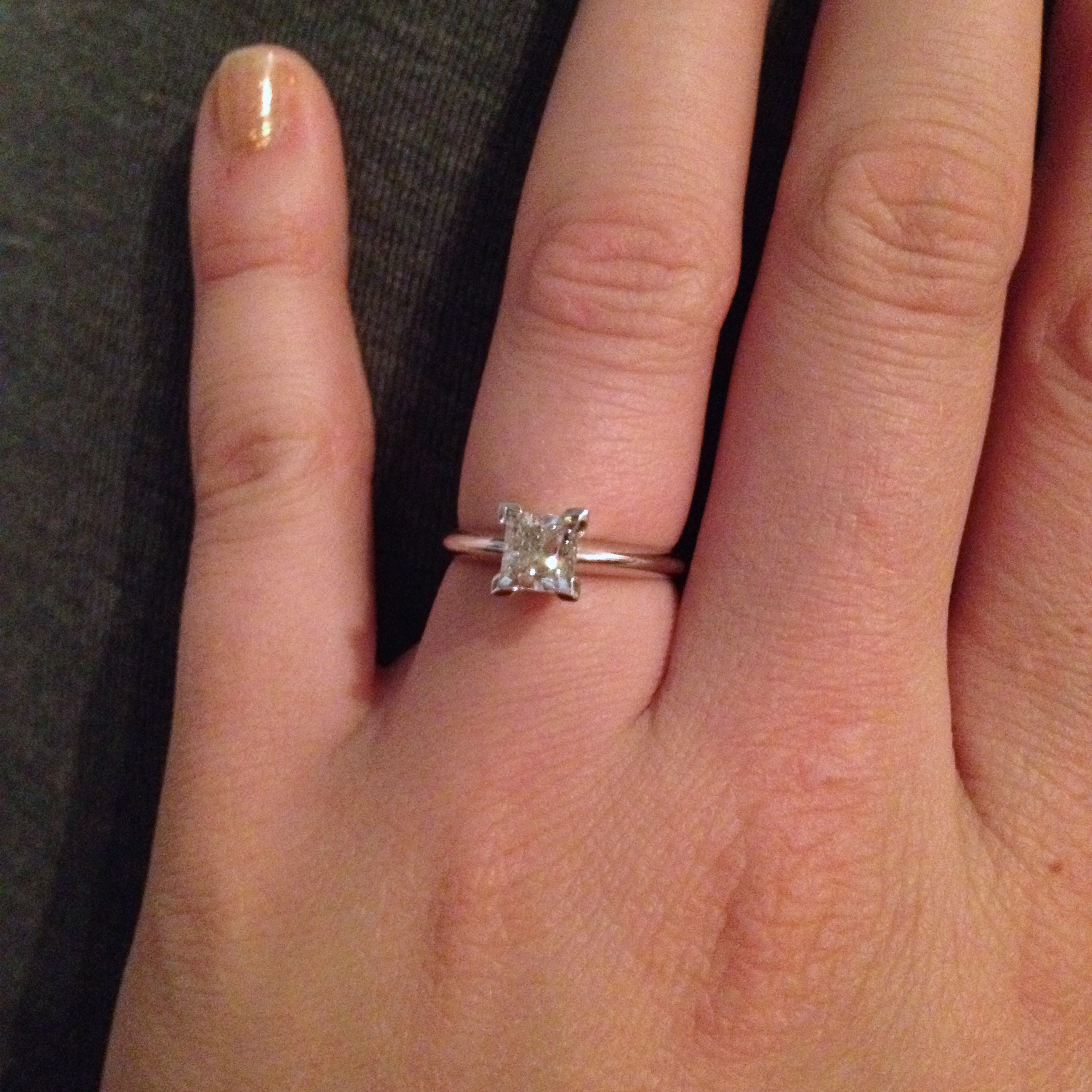 1 carat diamond engagement ring on finger